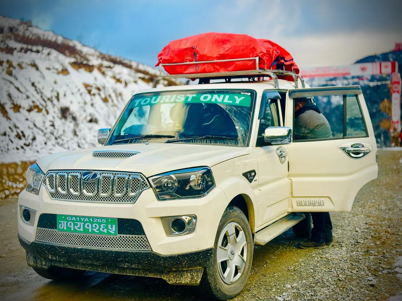 AM Travels Scorpio jeep parked on a snowy mountain road